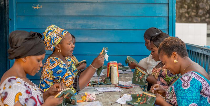 Embroiderers from "L’Ecole des Femmes" making the pouch celebrating 10 years of collaboration between Sisley and KISANY