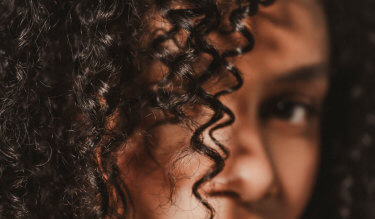 Hair Rituel model with tightly curled hair